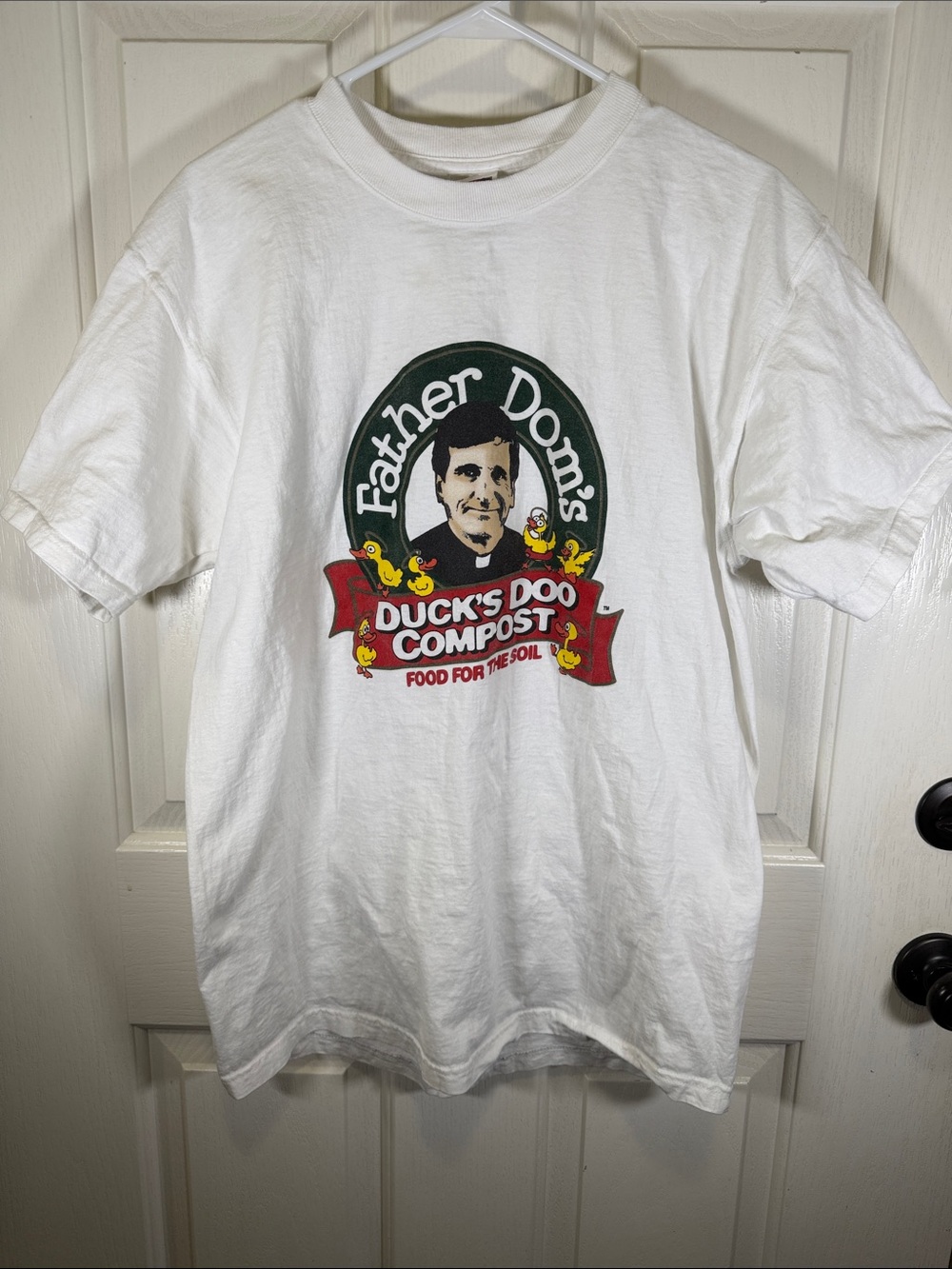 Father Dom’s Duck’s Doo Compost White Graphic Tee with Red and Green Logo